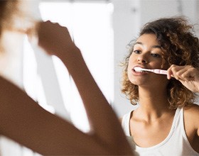 Patient in Boca Raton brushing after teeth whitening